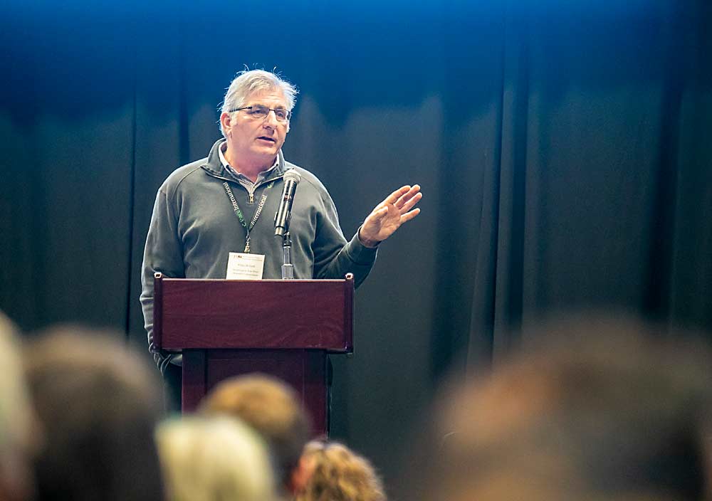 Mike Willett, the retired manager of the Washington Tree Fruit Research Commission, will deliver the Batjer Memorial Lecture at the 2021 Washington State Tree Fruit Association annual meeting, to be held in-person this month in Yakima. Pictured above, he speaks at the 2018 event. (TJ Mullinax/Good Fruit Grower)