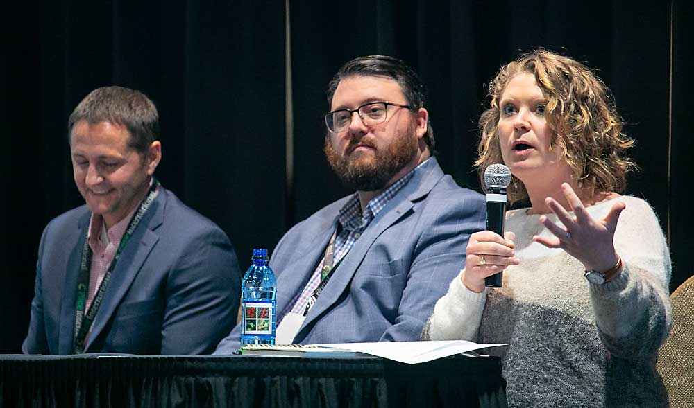Catherine Gipe-Stewart, right, director of marketing for Domex Superfresh Growers, discusses the organic apple market as part of a panel including Garrett Joeckel of CMI Orchards, center, and Tate Mathison of Stemilt Growers at the WSTFA Annual Meeting. (TJ Mullinax/Good Fruit Grower)