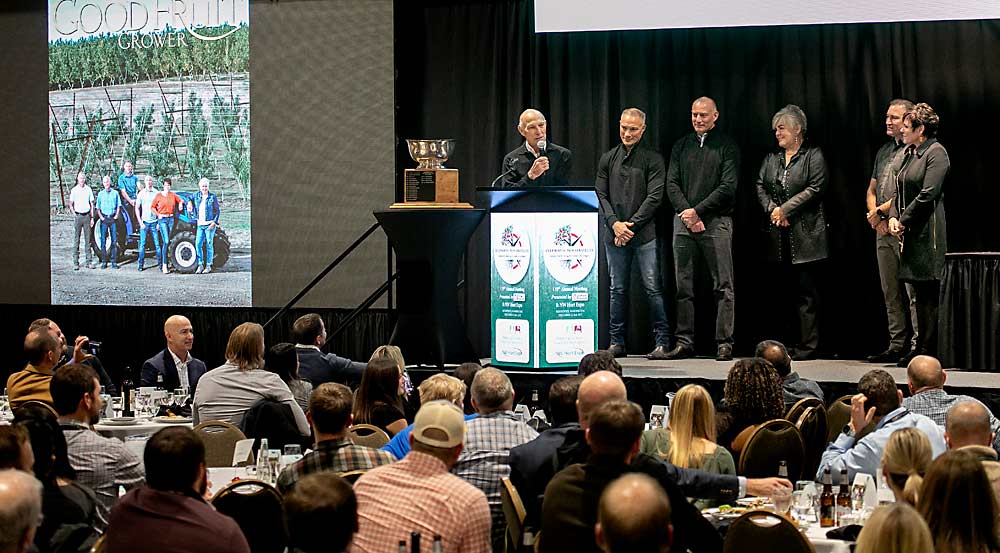 From left: Bill, Pete, David, Holly Douglas Wilson, John and Jill Douglas accept the Good Fruit Growers of the Year Award during the 119th Washington State Tree Fruit Association Annual Meeting banquet on Dec. 5 in Kennewick, Washington. (TJ Mullinax/Good Fruit Grower)