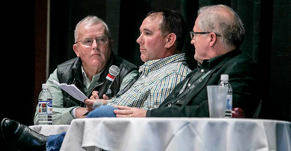 Led by Tom Auvil, left, Travis Allan, center, and Don Gibson talk about several challenges tree fruit growers face during the first day of the Washington State Tree Fruit Association Annual Meeting in December in Wenatchee, Washington. (TJ Mullinax/Good Fruit Grower)