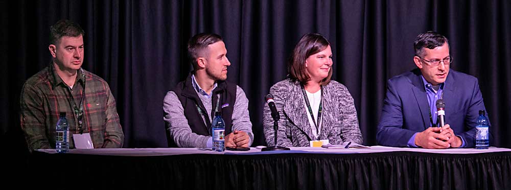 From left: Chris McCarthy, CEO of Auvil Fruit; Scott Porter of Cascadia Capital; Kelli Visser of the Larson Gross accounting firm; and Jared England, general manager of Manson Growers, take part in a panel discussion at the Washington State Tree Fruit Association Annual Meeting in December. (TJ Mullinax/Good Fruit Grower)