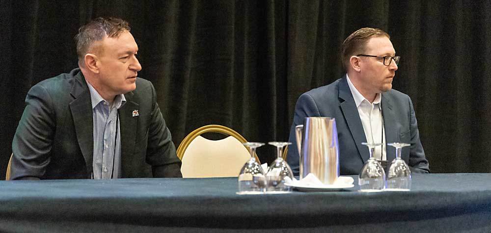 Michigan Apple Committee regional account manager John Woodall, left, and Michigan State University economics professor Zach Rutledge listen during a panel discussion of retail and labor trends during the International Fruit Tree Association’s 66th annual conference in Grand Rapids, Michigan, in February. (Matt Milkovich/Good Fruit Grower)