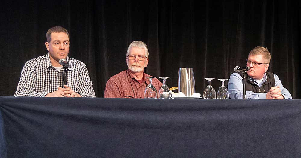 From left, Michigan growers Trever Meachum, Dave Rennhack and Chris Kropf talk about the EverCrisp apple during the International Fruit Tree Association’s annual conference in Grand Rapids, Michigan, in February. (Matt Milkovich/Good Fruit Grower)