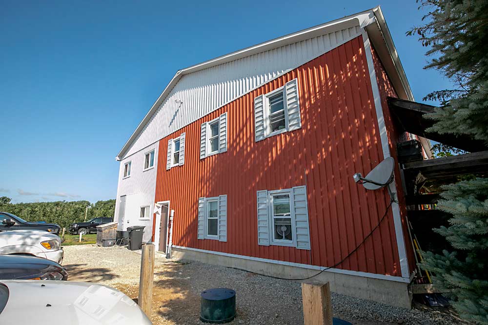 Botden Orchards’ temporary foreign worker housing facility is divided largely into two zones, with housing and break areas on one side (in red) and kitchen, laundry and cleaning areas on the other side. (TJ Mullinax/Good Fruit Grower)