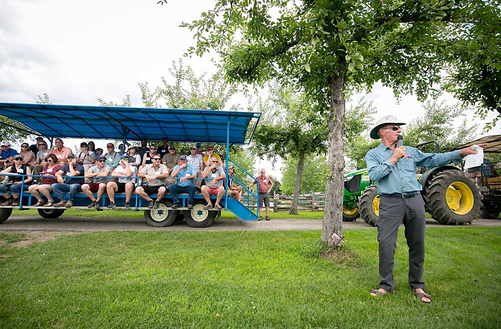 Tom Chudleigh tells 2019 IFTA attendees he wants his apples to be “chin-dripping juicy, right on the tree,” at Chudleigh’s Farm — all except the large Winter Banana apple trees, like the ones in the background that line the farm pathways for customer shade. (TJ Mullinax/Good Fruit Grower)