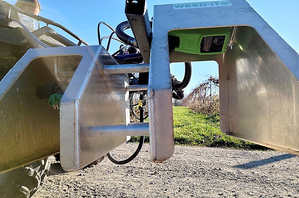 The WEED-IT Quadro’s sensors emit blue light, which is absorbed by chlorophyll in the weeds. The chlorophyll reacts by emitting a near-infrared signal, which is received and analyzed by the sensors. Spray booms connected to the sensors then spray the weeds. (Courtesy Sushila Chaudhari/Michigan State University)