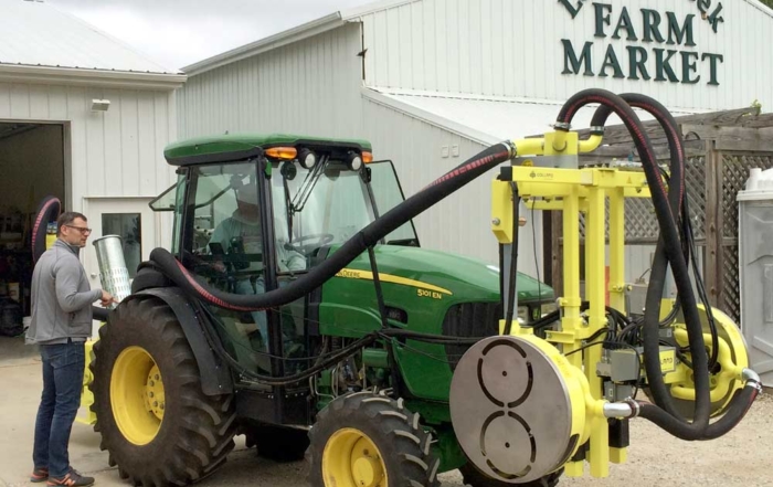 A Collard pneumatic leaf remover, shown here mounted to the front of a tractor and used in the MSU study, has spinning air compressors that shred grape leaves on both sides as it moves down the row. (Photo courtesy of Josh VanderWeide)