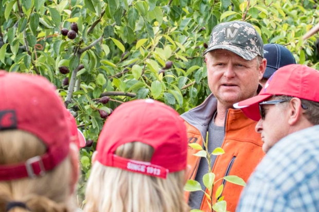 Rudy Prey speaks to Interpera attendees at his farm near Leavenworth, Washington, in June. He calls the Wenatchee Valley one of the best places in the world to grow pears and discussed his innovative ways to boost density in hilly, snowy terrain. (TJ Mullinax/Good Fruit Grower)