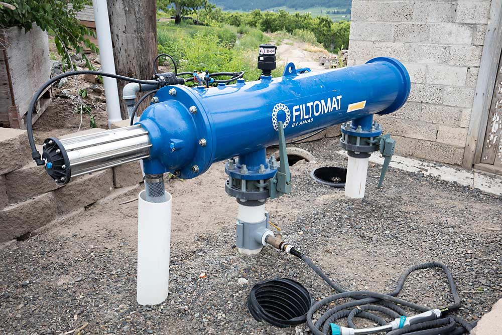 The upgrade from impact sprinklers to microsprinklers at the Caudles’ farm reduced runoff and increased water penetration into the subsoil, but the switch also required upgrading to a new self-cleaning filter. (TJ Mullinax/Good Fruit Grower)