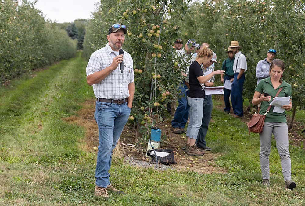 Grower Brett Kast, speaking during the Cornell tour in August, shifted his initial preemergent herbicide applications from spring to fall. He prioritizes blocks with heavy weed pressure after harvest. If he doesn’t have time to treat every block in the fall, he finishes the following spring. The new approach saves him time during the busy spring season and also provides better weed control. (Matt Milkovich/Good Fruit Grower)