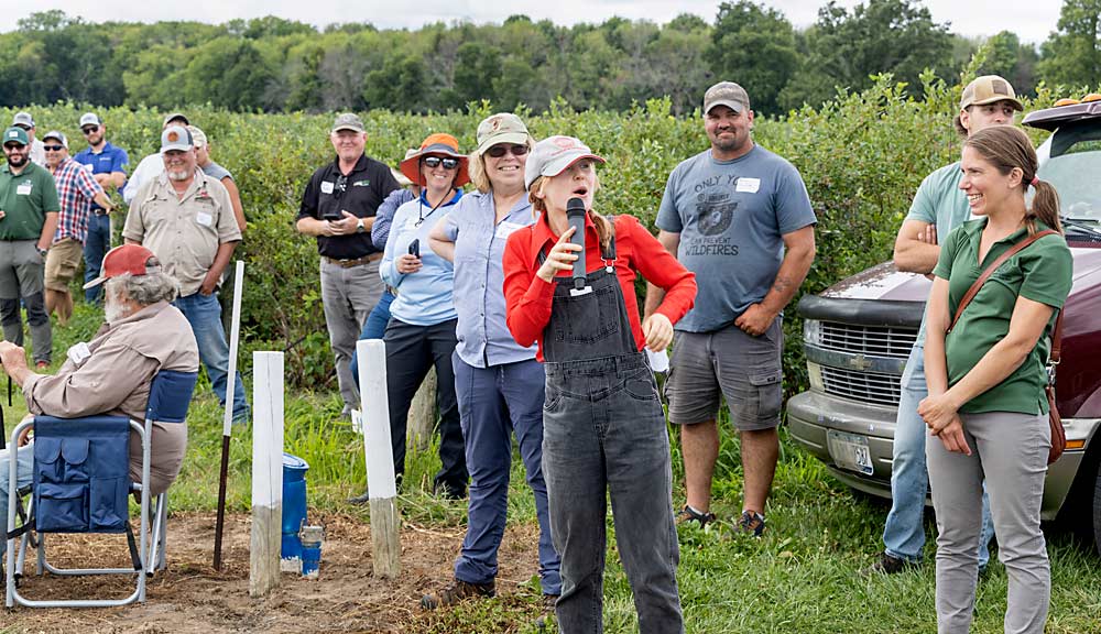 Anya Osatuke, Cornell University’s Western New York small fruit extension specialist, discusses blueberries during the Lake Ontario Fruit Program tour in August. In a blueberry patch at Orchard Dale Fruit Co. in Waterport, she talked about mechanical harvest, potential markets and other things to consider for New York growers who are contemplating new plantings. (Matt Milkovich/Good Fruit Grower)