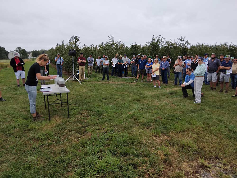 Cornell soil specialist Deborah Aller, left, displays soil sampling techniques during the Lake Ontario Fruit Program’s annual summer tour in Orleans County, New York. (Matt Milkovich/Good Fruit Grower)