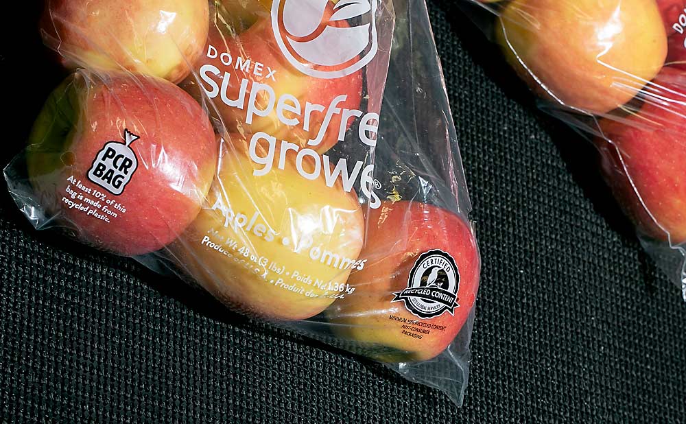 Ambrosia apples packaged in a new bag made of recycled plastic in December at Monson Fruit in Selah, Washington. Such bags are one way the tree fruit industry is trying to keep up with conflicting demands of sustainable packaging and consumer convenience. (Photo illustration by TJ Mullinax/Good Fruit Grower)
