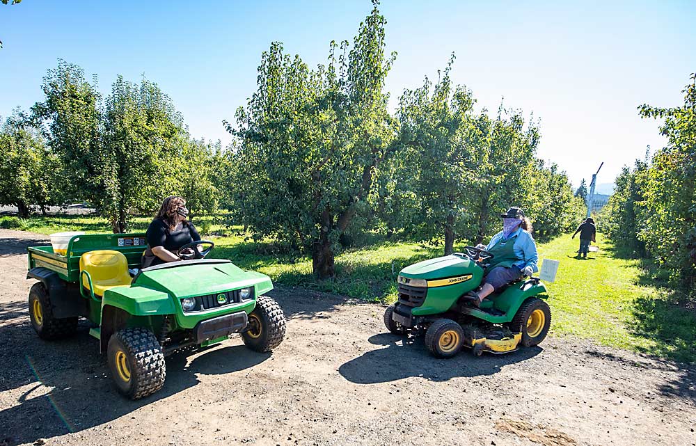 Trina McAlexander and her mother, Ruthie, right, check on U-pick customers at the farm that has been in their family for three generations. (TJ Mullinax/Good Fruit Grower)