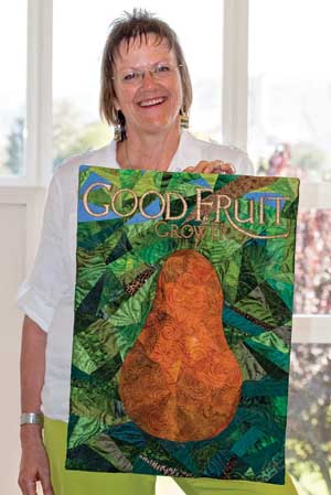 Nancy Born displays her retirement gift from Geraldine Warner.