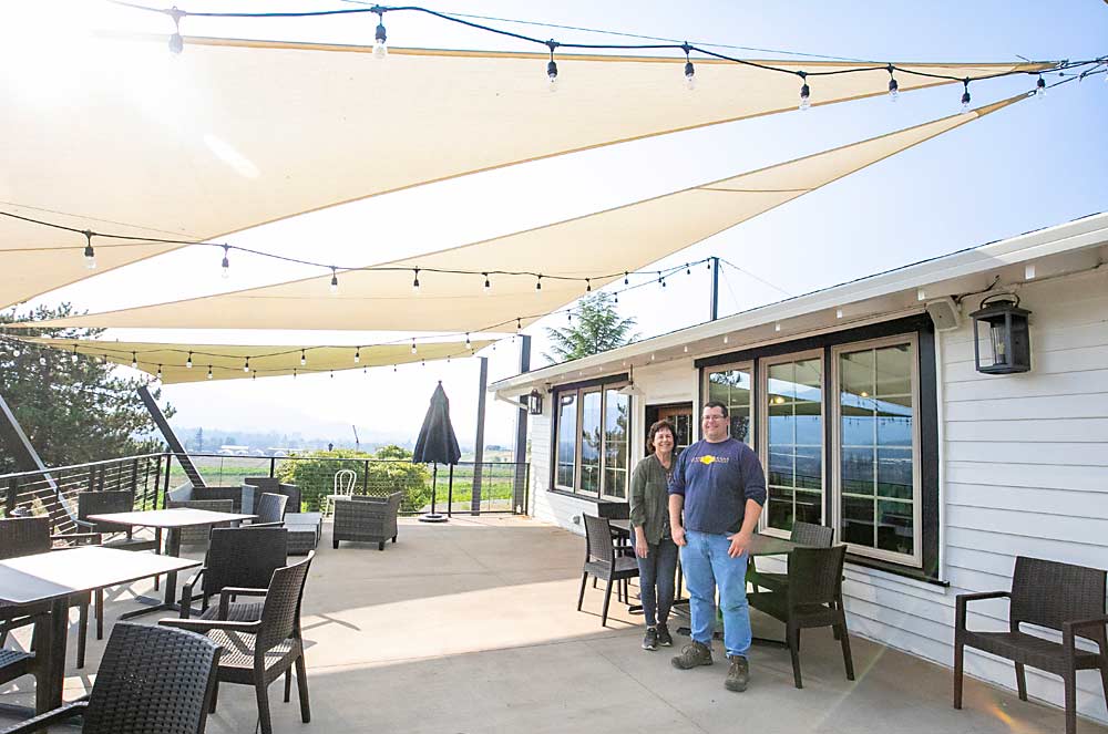 “So much depends on factors outside our control. We just have to be flexible and be able to pivot,” said Sean Naumes, standing with his mother, Laura, on the patio of the family’s wine tasting room. (TJ Mullinax/Good Fruit Grower)
