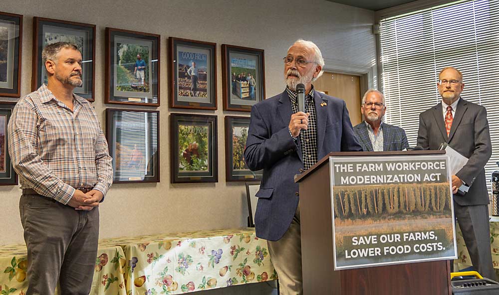 Rep. Dan Newhouse, R-Wash., speaks to the media following a discussion with a diverse group of agriculture stakeholders at the Washington State Fruit Commission building on Nov. 2 in Yakima. Left to right, behind Newhouse: Jason Sheehan, dairy farmer from Sunnyside; Tony Freytag, executive vice president of Crunch Pak; and Mark Powers, president of the Northwest Horticultural Council. (Kate Prengaman/Good Fruit Grower)