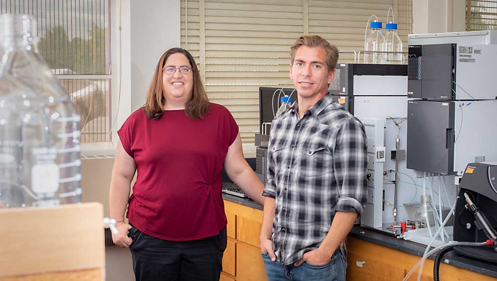 Oregon State University set up a new smoke science lab in 2021, with $2.7 million in support from the state. Professor Elizabeth Tomasino and postdoctoral researcher Darrell Cole Cerrato stand in the lab, which includes high-powered mass spectrometers they will use to identify free and bound smoke compounds in wine samples. (TJ Mullinax/Good Fruit Grower)