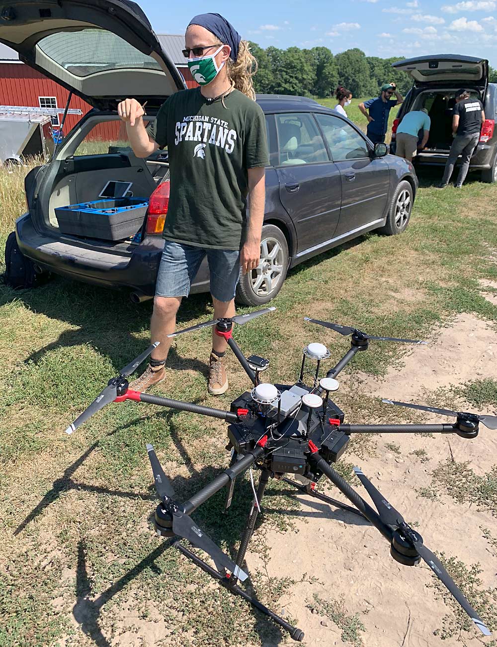 Ruben Ulbrich, a research technologist in MSU professor Bruno Basso’s lab, prepares to fly a drone equipped with sensors that measure plant height, reflected light from plants and canopy temperature. (Courtesy Paolo Sabbatini/Michigan State University)