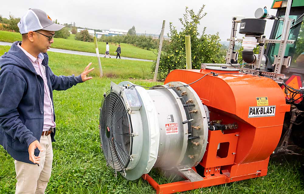 Professor Long He demonstrates a test airblast sprayer at Penn State University’s Fruit Research and Extension Center in Biglerville in September. The sprayer uses a lidar-guided vision system to adjust the spray pattern when driving through tree rows. (TJ Mullinax/Good Fruit Grower)