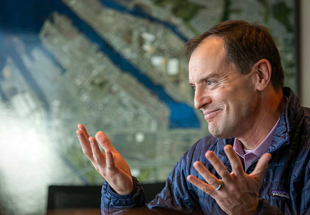 Steve Balaski from Northwest Seaport Alliance talks to Good Fruit Grower at the Port of Seattle’s Terminal 46 in downtown Seattle in November. In the background hangs an aerial photo of the Port of Tacoma. (TJ Mullinax/Good Fruit Grower)