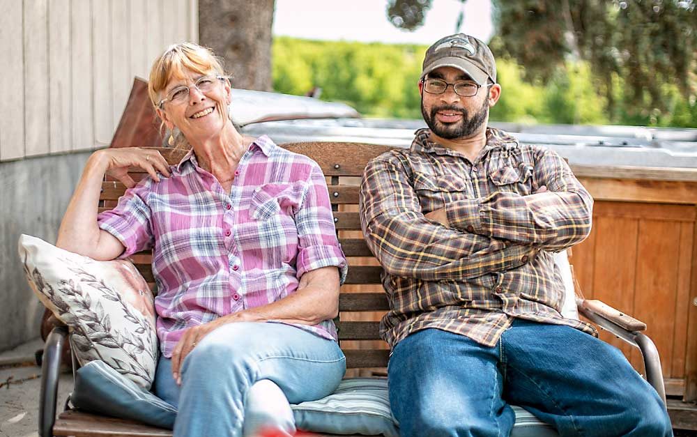 Camille Smith, left, and son-in-law Jabin Green at their family farm, Smith Orchards, in Wapato, Washington, in late May. (TJ Mullinax/Good Fruit Grower)