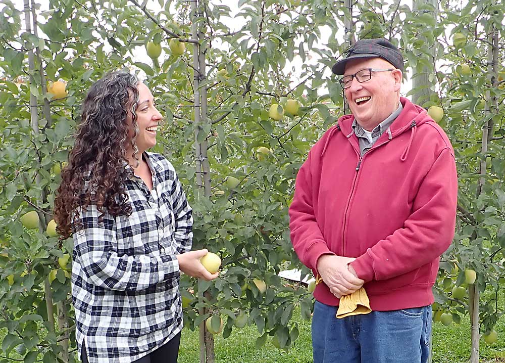 John King, at right, co-owner of King Orchards in the northwestern Lower Peninsula of Michigan, and project manager Juliette McAvoy, King’s daughter, have witnessed numerous recent weather-related issues in the orchard, ranging from flooding and erosion to damaging weather swings and hail, that make growing more challenging, they said. (Leslie Mertz/for Good Fruit Grower)