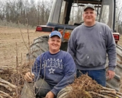Twin Bee Orchard co-owner Tony Blattner and his son Nathan, left, take a break while planting 4,600 Smitten trees in spring 2016. Twin Bee, in west-central Michigan, has 135 acres of apples, including Gala, Red Delicious, Fuji, Honeycrisp, McIntosh, Empire, Ida Red and Jonagolds. (Courtesy Twin Bee Orchard LLC.)