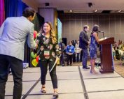 Scholarship recipient Anahi Goninez shakes hands with Chris Willett, WAEF chair, at the organization’s awards luncheon in Yakima in late July. (Ross Courtney/Good Fruit Grower)
