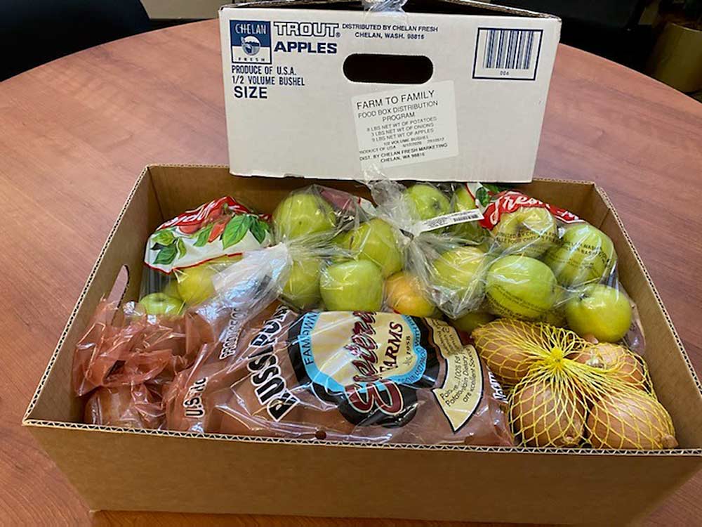 An apple, potato and onion box packed by Chelan Fresh is one of the first the company will ship to nonprofit groups serving families in need as part of the U.S. Department of Agriculture’s pandemic response Farmers to Families Food Box Program. (Courtesy Bryan Peebles)