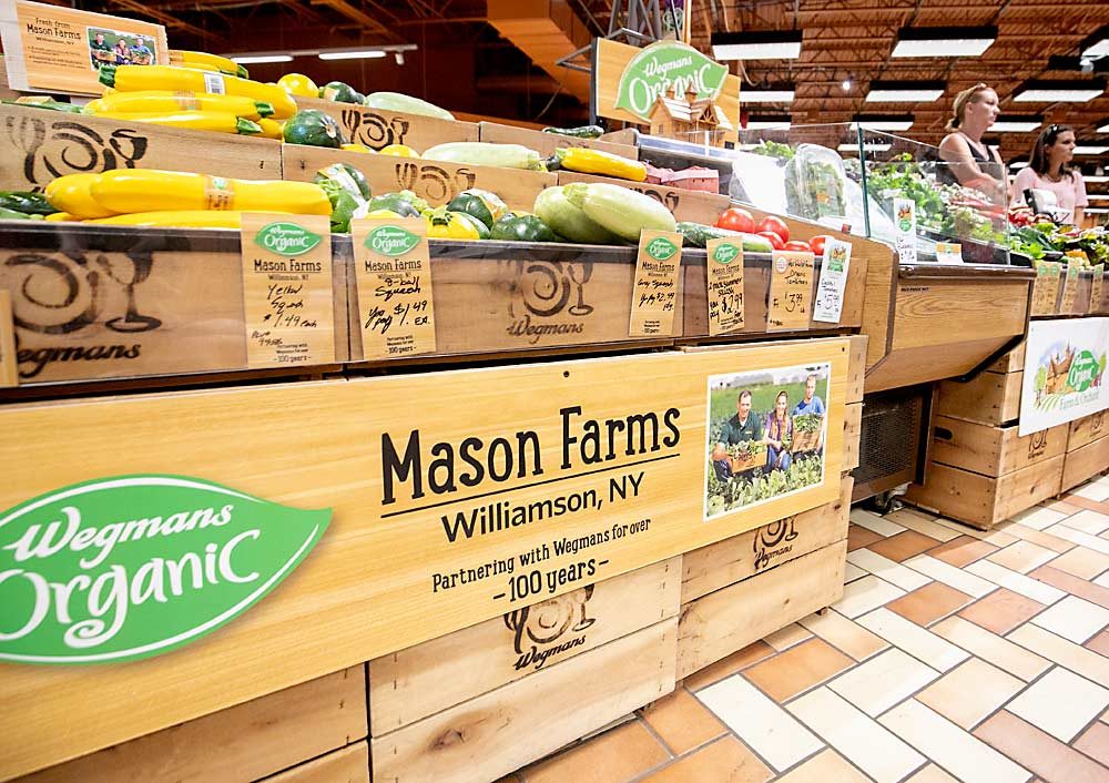 Wegmans’ customers want local and organic produce, so the stores highlight locally grown produce and farmers in an organic display that evokes a farm market scene. (TJ Mullinax/Good Fruit Grower)