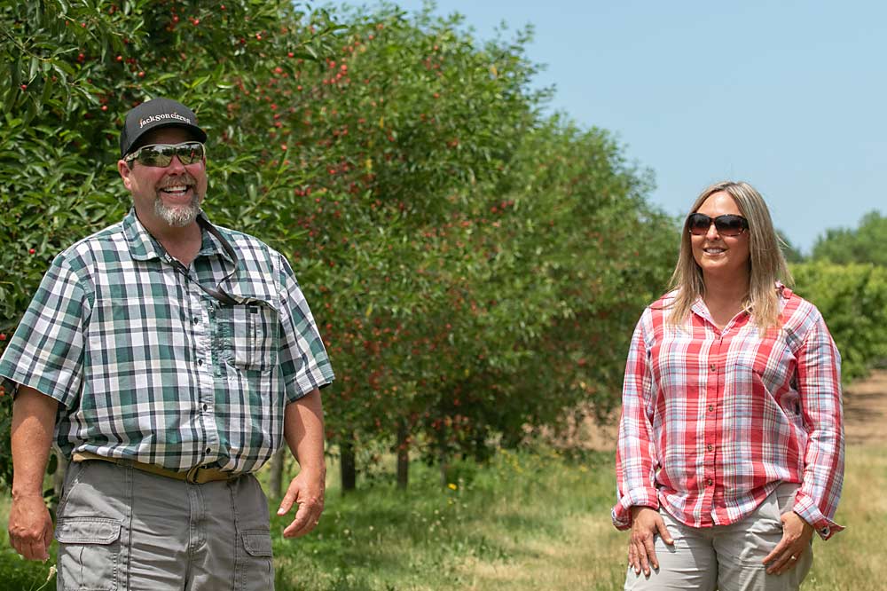 Grower Marc Willmeng and his wife, Christina, in a tart cherry block in their Watervliet orchard in June 2022. His harvest starts with cherries then moves to peaches and apples. (TJ Mullinax/Good Fruit Grower)