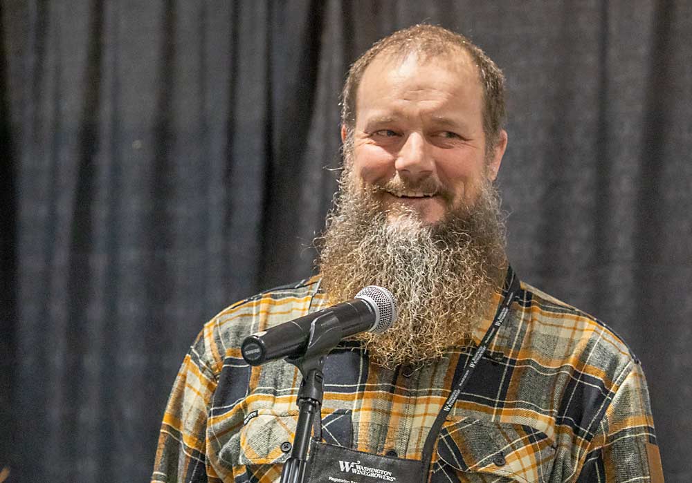 Todd Newhouse, owner of Upland Vineyards, receives the Erick Hanson Memorial Winegrape Grower of the Year award during the 2022 WineVit convention and trade show on Feb. 10 at the Three Rivers Convention Center in Kennewick, Washington. (TJ Mullinax/Good Fruit Grower)