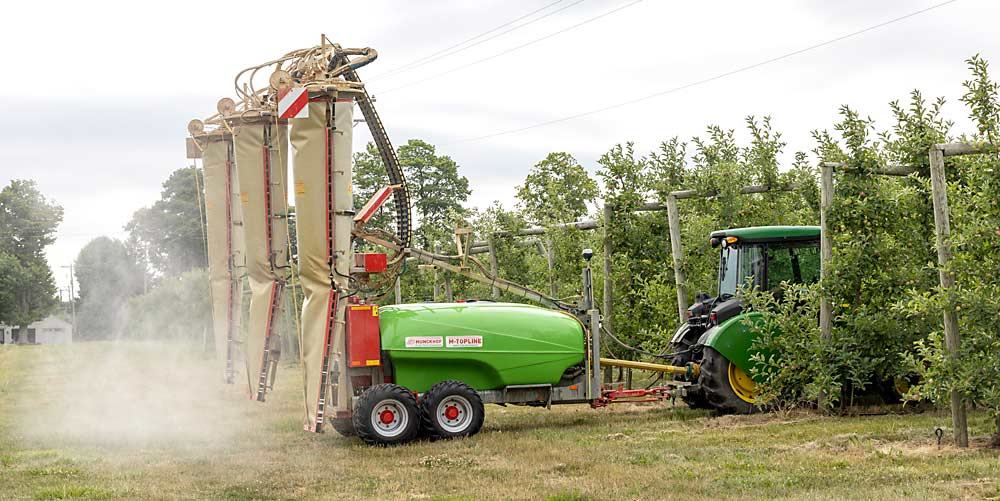 A tractor pulls grower Mike Wittenbach’s Munckhof three-row orchard sprayer through a Gala block in July, during a demonstration. (Matt Milkovich/Good Fruit Grower)