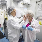 Cleanliness is essential to Woot Froot's business. Kim Gaarde and Brittnie (Gaarde) Hammack go through the clean room before entering the cutting room on April 9, 2015. (TJ Mullinax/Good Fruit Grower)