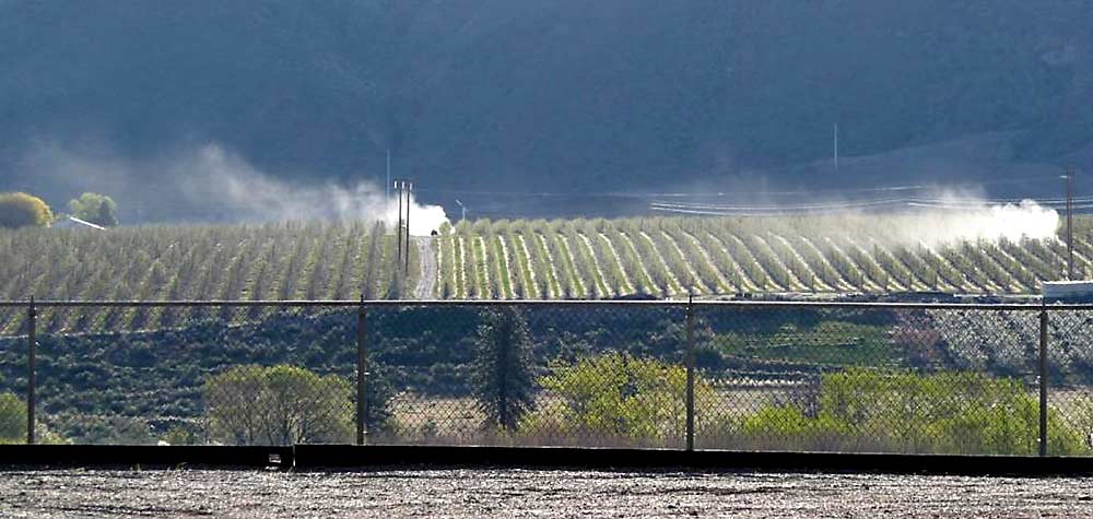 Drift from airblast sprayers is visible from a distance. This spring, Washington State Department of Agriculture inspectors will be on the lookout for airblast sprayer drift as part of a new drift-focused inspection program, according to pesticide compliance program manager Tim Schultz. Seeing drift like this will now prompt WSDA inspectors to launch a new drift-focused inspection that aims to encourage growers and applicators to be more diligent about sprayer calibration and weather assessments before applying pesticides. (Courtesy Washington State Department of Agriculture)