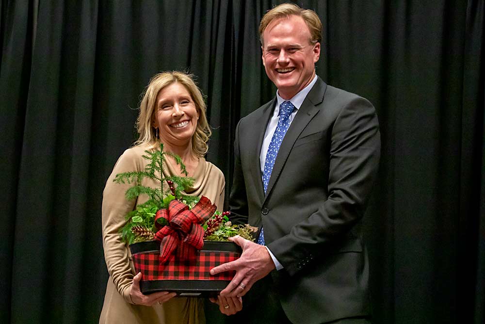 Sean Gilbert, right, thanks outgoing Washington Apple Education Foundation executive director Jennifer Witherbee for her service to the industry. (TJ Mullinax/Good Fruit Grower)