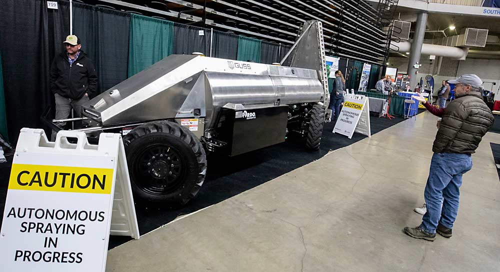 Caution not required as the Mini Guss autonomous sprayer makes its appearance on the first day of the Washington State Tree Fruit Association's NW Hort Expo on Monday, Dec. 6, 2021, at the Yakima Valley SunDome in Yakima, Washington. The Mini Guss is specially designed to operate in tree fruit orchards. (TJ Mullinax/Good Fruit Grower)
