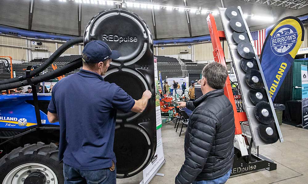 Airblast machines such as the RedPulse leaf remover are one hand to see during the first day of the Washington State Tree Fruit Association's NW Hort Expo on Monday, December 6, 2021 at the Yakima Valley SunDome in Yakima, Washington. (TJ Mullinax/Good Fruit Grower)