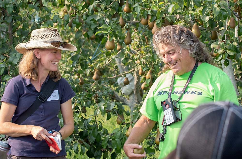 Grower Dain Craver and Washington State University’s Tianna DuPont share a laugh during one of WSU’s field days targeting younger growers at KDS Orchards in Royal City, Washington. (TJ Mullinax/Good Fruit Grower)